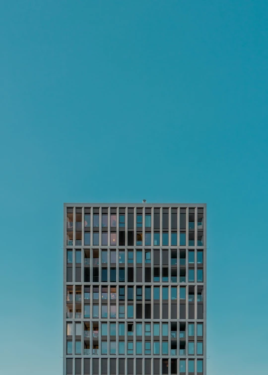 a tall building sitting on top of a lush green field, unsplash contest winner, postminimalism, cloudless blue sky, 2 5 6 x 2 5 6, brutalist city architecture, modern minimalist f 2 0