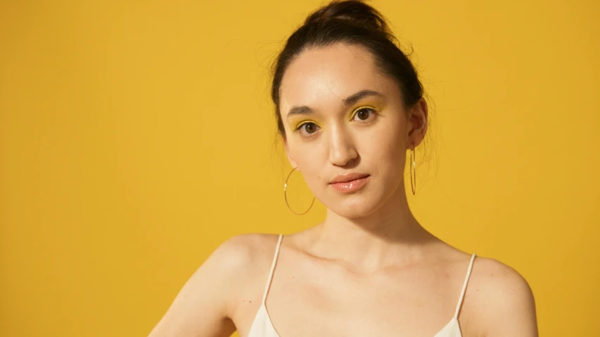 a woman in a white dress posing for a picture, an album cover, inspired by Josefina Tanganelli Plana, trending on pexels, photorealism, wearing yellow croptop, big hooped earrings, color photograph portrait 4k, portrait sophie mudd