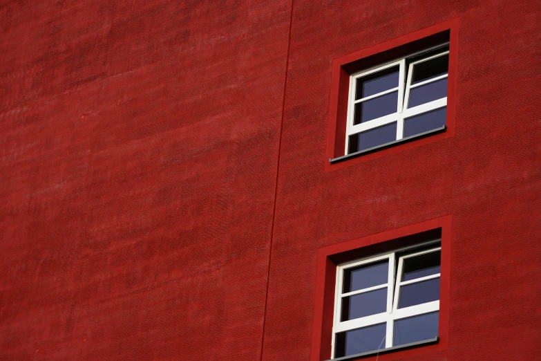 a red building with two windows and a clock, inspired by Bauhaus, pexels contest winner, square lines, deep colour, red