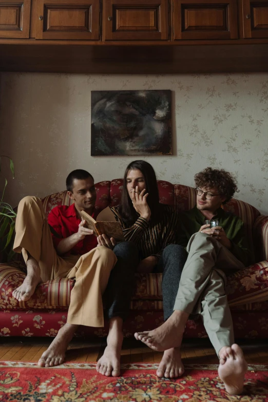 a group of people sitting on top of a couch, pexels contest winner, antipodeans, trio, sovietwave aesthetic, large portrait, ( ( theatrical ) )