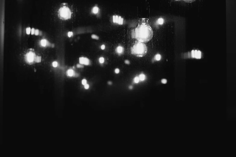 a black and white photo of a bunch of lights, a black and white photo, unsplash, light and space, alternate album cover, nightcafe, tiny stars, gloomy mood