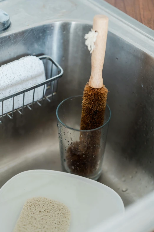 a close up of a sink with a brush in it, by Nina Hamnett, umami, brown, tall, action shot