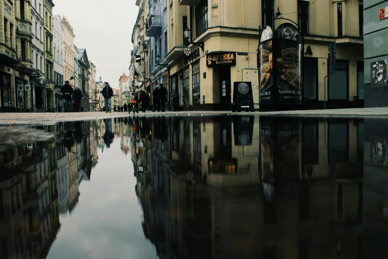 a puddle of water in the middle of a city street, by Emma Andijewska, pexels contest winner, square, ultrawide cinematic, hd footage, thumbnail