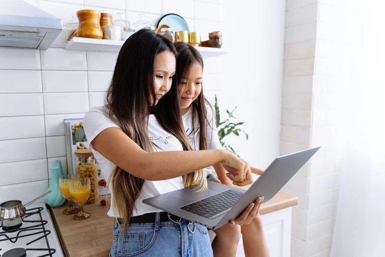 two women sitting on a kitchen counter looking at a laptop, trending on pexels, asian girl with long hair, with a kid, avatar image, instruction