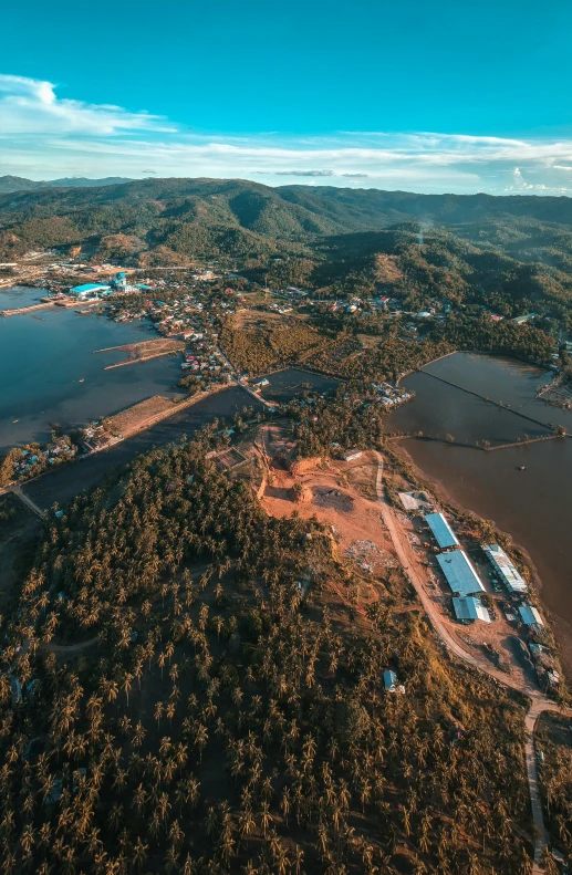 a large body of water surrounded by trees, by Marshall Arisman, pexels contest winner, dau-al-set, flooded fishing village, “ aerial view of a mountain, industrial surrounding, thawan duchanee
