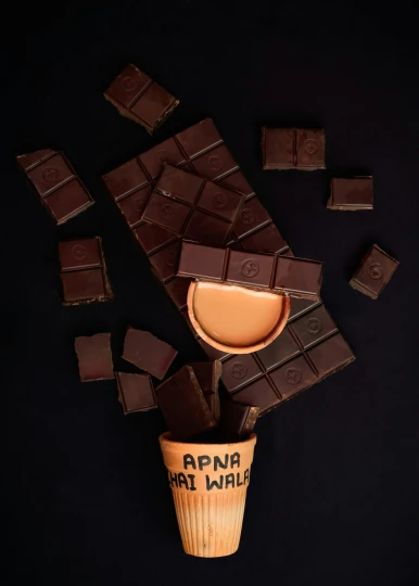 a cup that has some kind of chocolate in it, inspired by Perin del Vaga, trending on unsplash, conceptual art, with a square, anna nikonova aka newmilky, made of smooth black goo, snacks