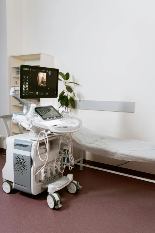 a hospital room with a bed and a monitor, grey, photographed from the back, gold, cart