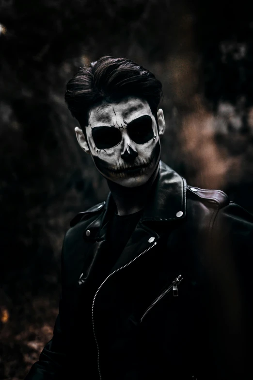 a man with a skeleton face painted on his face, an album cover, trending on pexels, wearing leather jacket, dark photo, cinematic outfit photo, discord profile picture