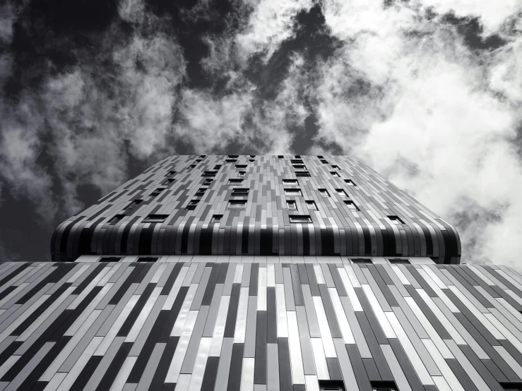 a black and white photo of a tall building, by Patrick Pietropoli, unsplash, dramatic skies, metal cladding wall, a wooden, taken with canon 5d mk4