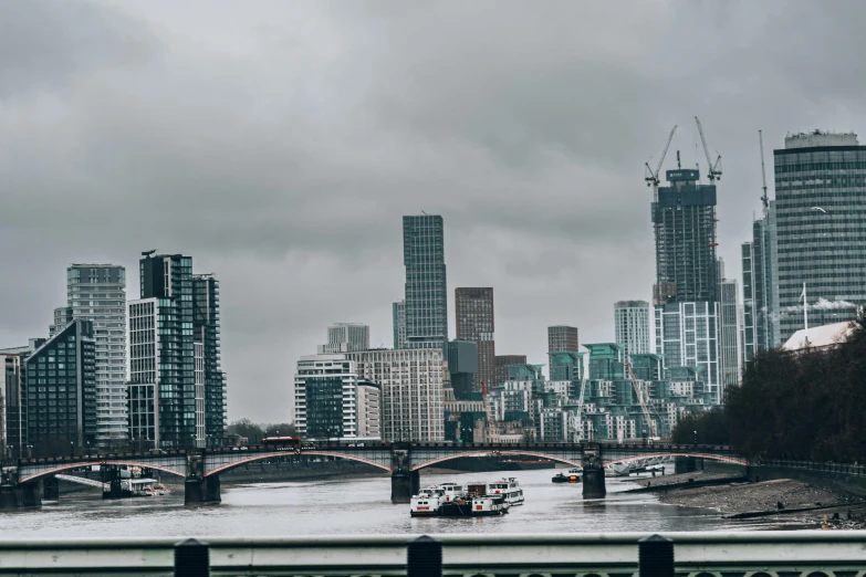 a boat traveling down a river next to tall buildings, inspired by Thomas Struth, pexels contest winner, brutalism, stormy overcast, 1 9 th century london, background image, all buildings on bridge