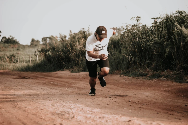 a man is running on a dirt road, pexels contest winner, wearing a tee shirt and combats, avatar image, action sports, athletic crossfit build