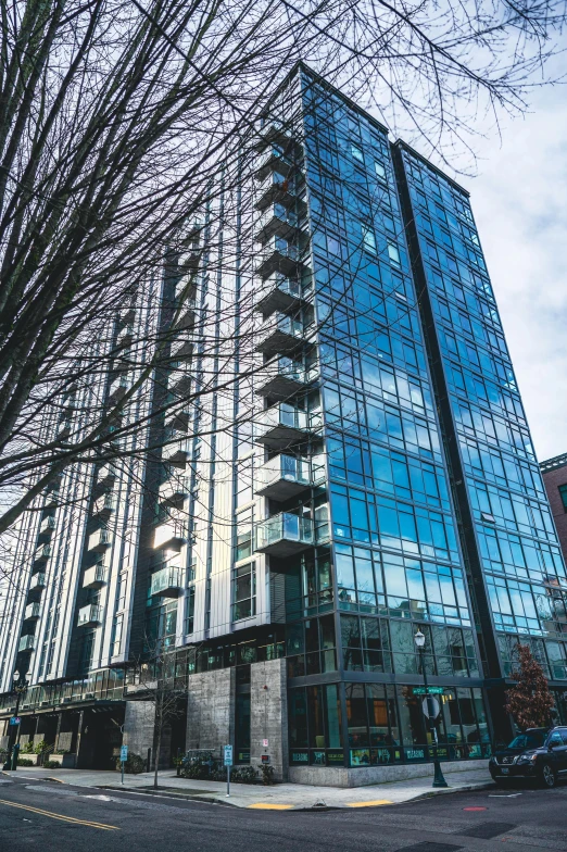 a tall building sitting on the side of a street, whistler, glass and steel, slide show, portland oregon