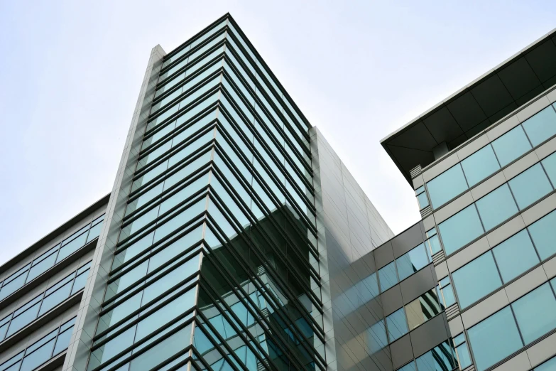 a couple of tall buildings next to each other, an album cover, inspired by Tadao Ando, unsplash, medical research facility, lots of glass details, iron cladding, up-angle view