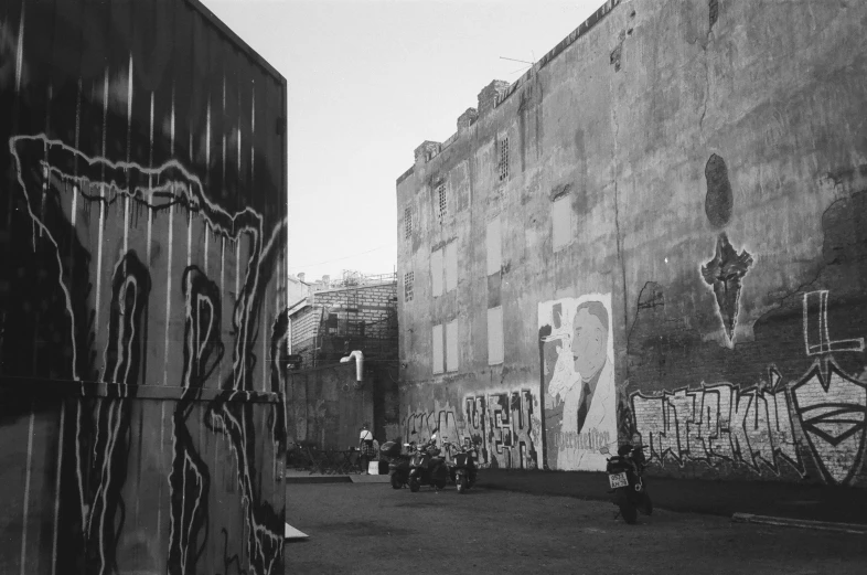 a black and white photo of graffiti on the side of a building, one motorbike in center of frame, portait photo, swedish urban landscape, the man in the wall