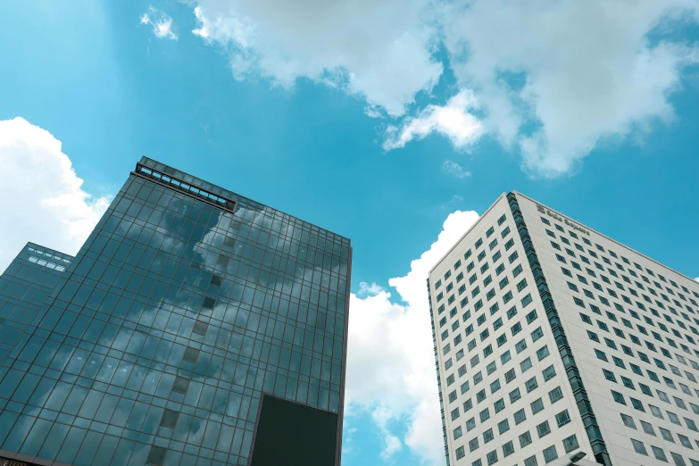 a couple of tall buildings sitting next to each other, a picture, unsplash, bauhaus, axure sky, 2 0 0 0's photo, multiple stories, high quality upload