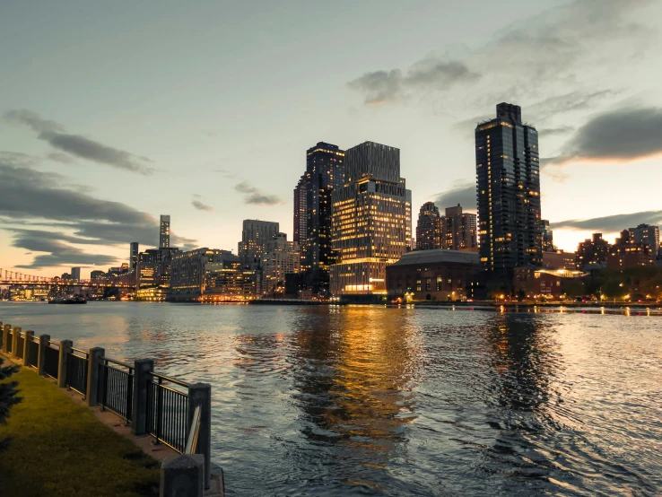 a body of water with a city in the background, at the golden hour, victorian harbour night, jen atkin, high-quality photo