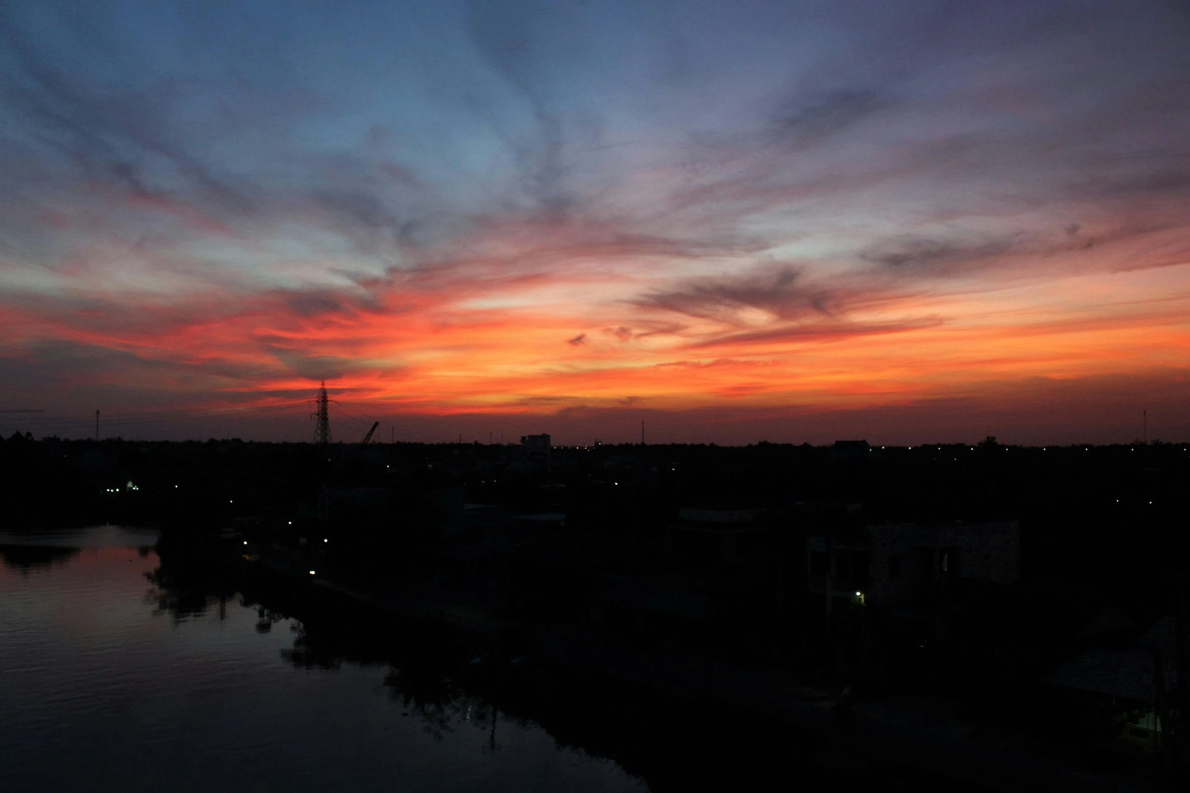 a large body of water with a sunset in the background, south jakarta, during night, album photo, 2022 photograph