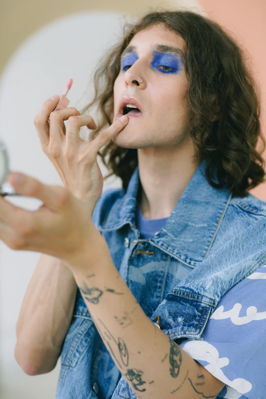 a man brushing his teeth in front of a mirror, an album cover, inspired by Winona Nelson, trending on pexels, blue body paint, joe keery, with professional makeup, stoner