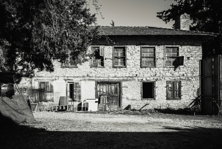 a black and white photo of an old house, a black and white photo, by Patrick Pietropoli, renaissance, rustic, tourist photo, flattened, farmhouse