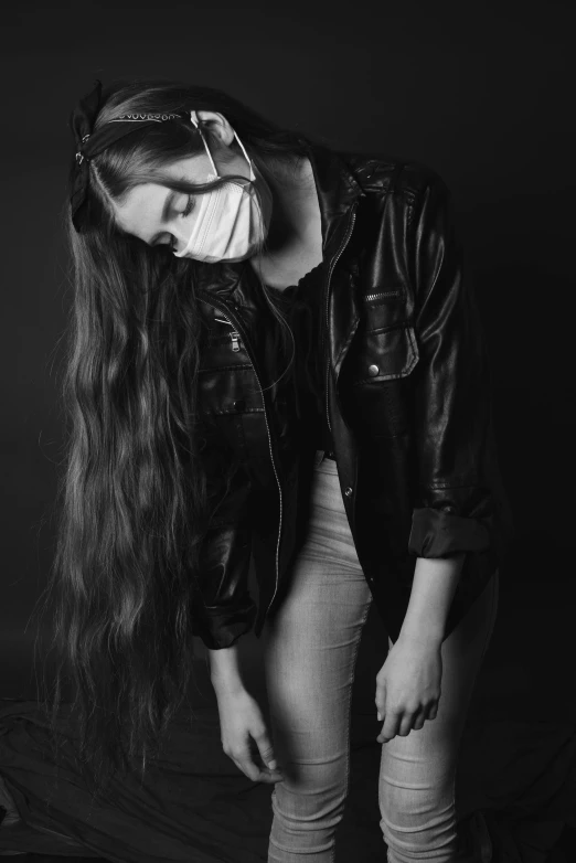 a black and white photo of a woman with long hair, pexels contest winner, wearing facemask, dressed in short leather jacket, helpless, ((restrained))