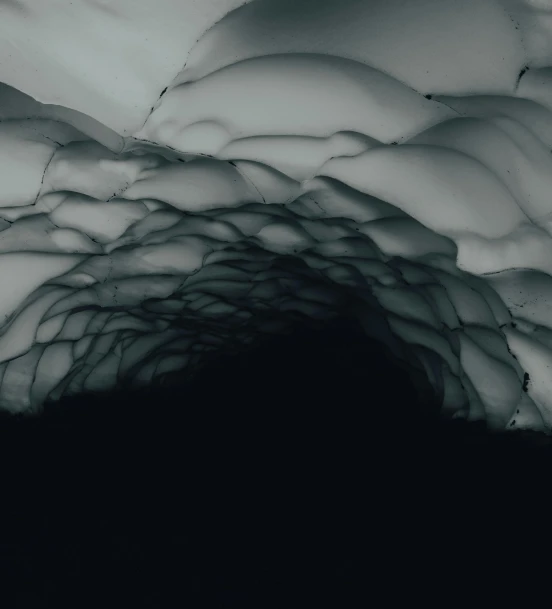 a black and white photo of an ice cave, inspired by Otto Piene, unsplash contest winner, conceptual art, 4k”, ceiling hides in the dark, ignant, mountainous