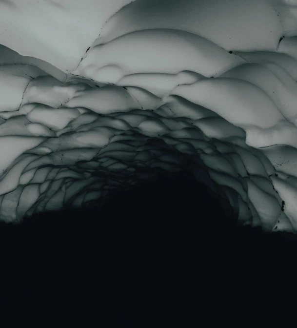 a black and white photo of an ice cave, inspired by Otto Piene, unsplash contest winner, conceptual art, 4k”, ceiling hides in the dark, ignant, mountainous