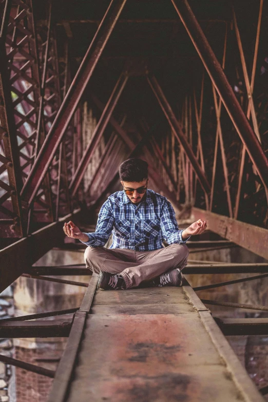 a man meditating in meditation on a bridge, a portrait, by Jason Felix, pexels contest winner, a portrait of rahul kohli, sitting under bridge, centered full body, mechanics