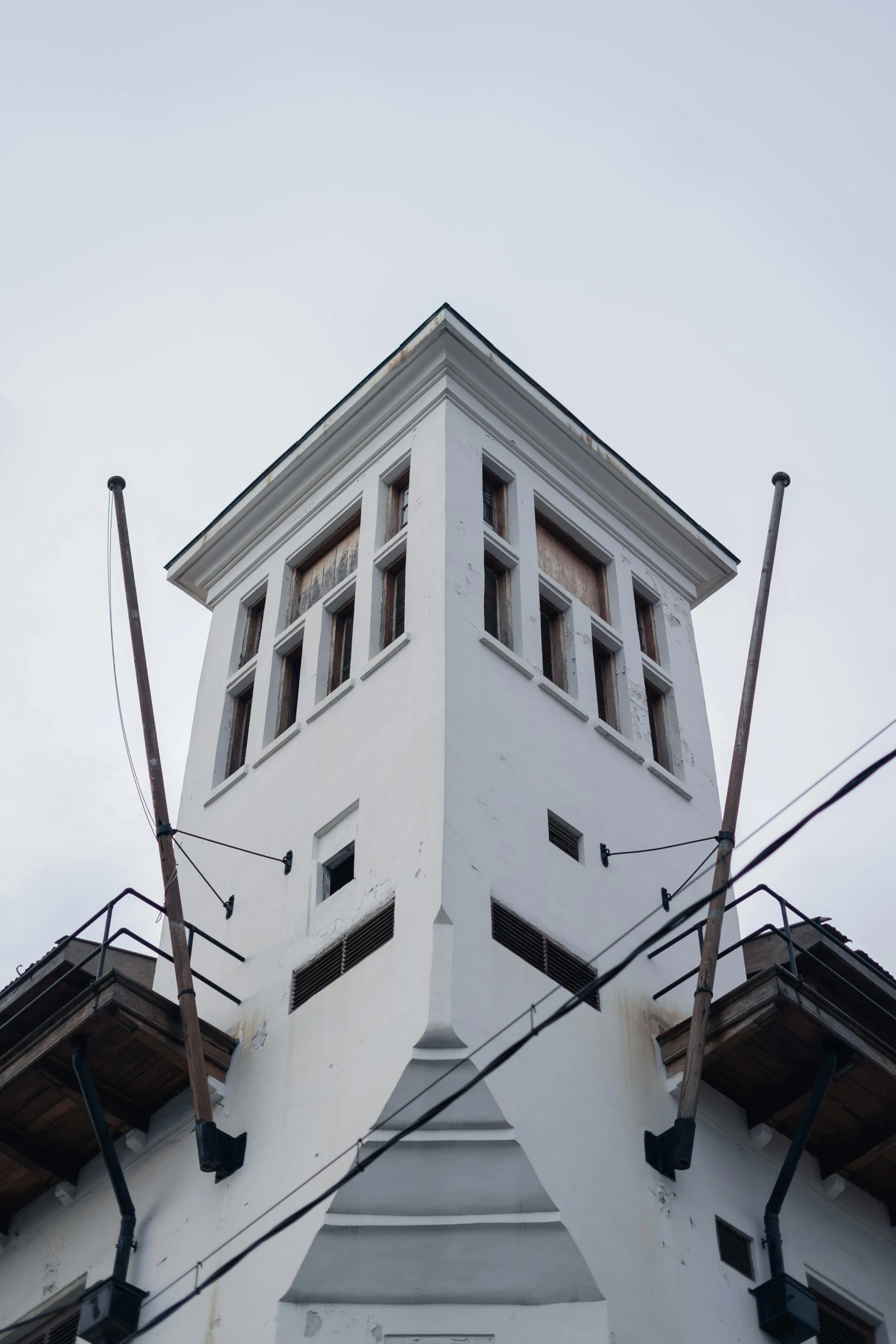 a tall white building with a clock tower, inspired by Wilhelm Marstrand, berlin secession, helsinki, gallows, top - side view, elevator