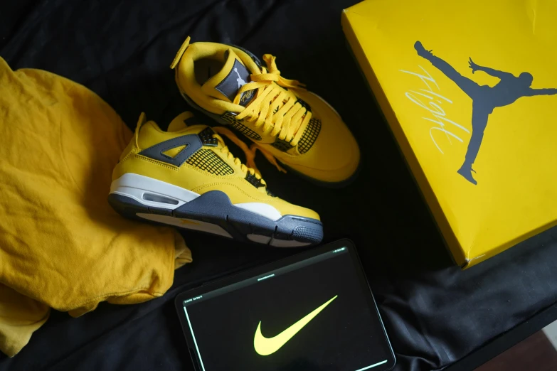 a pair of yellow shoes sitting next to a box, inspired by Jordan Grimmer, pexels contest winner, nike logo, game ready, # e 4 e 6 2 0, profile pic
