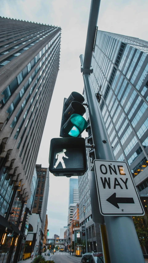 a green traffic light sitting on the side of a street, an album cover, unsplash contest winner, highrise business district, traffic signs, thumbnail, multiple stories