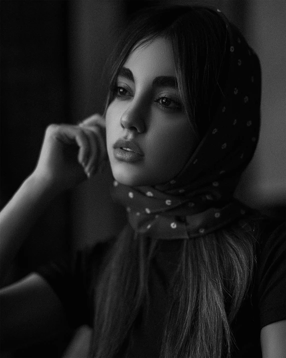 a black and white photo of a woman wearing a scarf, inspired by irakli nadar, unsplash contest winner, realism, portrait sophie mudd, young middle eastern woman, fashion shoot 8k, pouty