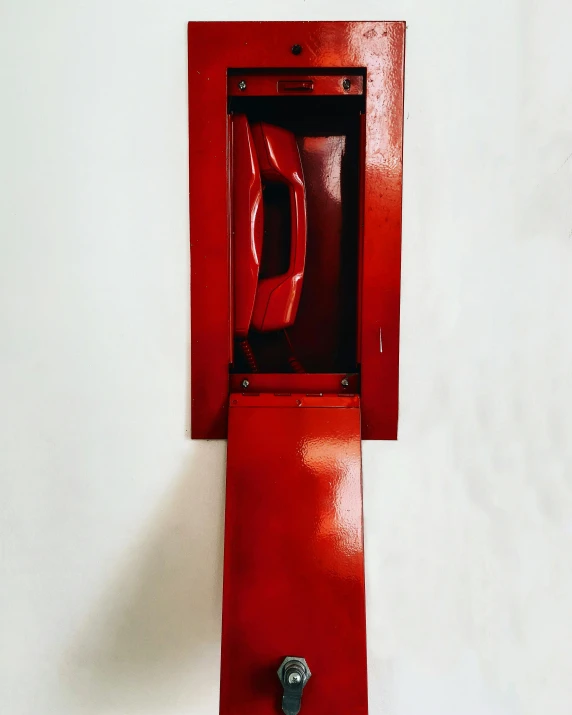 a red fire hydrant mounted to the side of a wall, by Glennray Tutor, modernism, inside its box, telephone, 9 0 s, laquer and steel