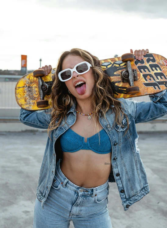 a woman holding a skateboard over her head, trending on pexels, wearing bra, wearing blue sunglasses, portrait sophie mudd, billboard image