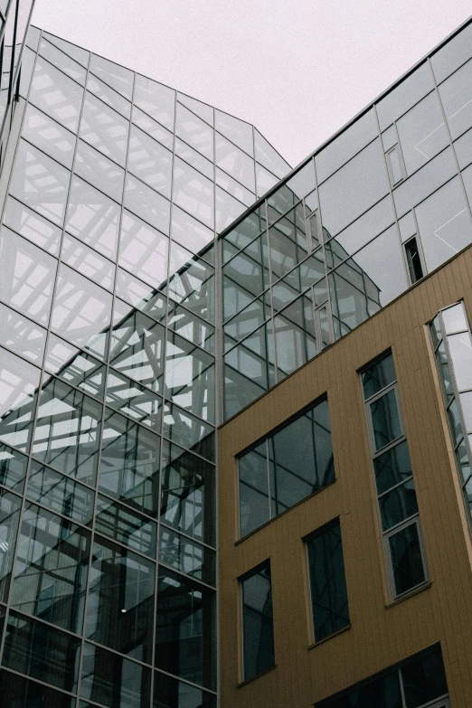 a couple of buildings that are next to each other, inspired by Thomas Struth, unsplash, lots of glass details, high quality photo, intricate detail?, steel window mullions