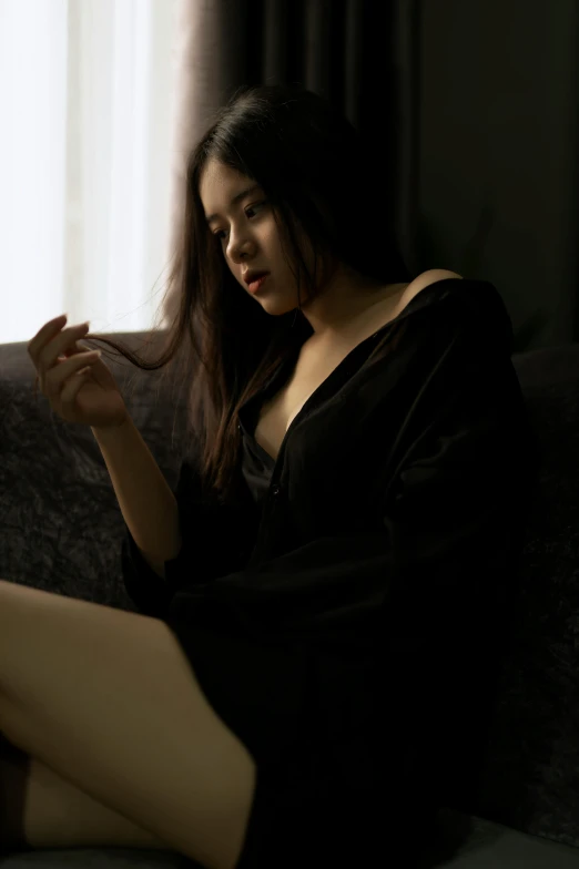 a woman sitting on a couch smoking a cigarette, inspired by Elsa Bleda, pexels contest winner, wearing a black robe, asian girl with long hair, revealing clothes, asian female