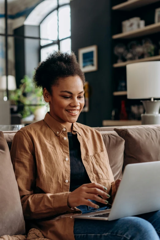 a woman sitting on a couch using a laptop, trending on pexels, renaissance, diverse, subtle smile, avatar image, inspect in inventory image