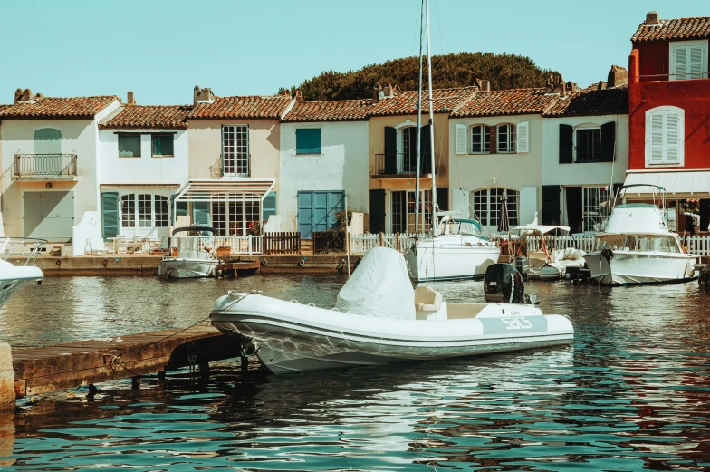 a number of boats in a body of water, by Raphaël Collin, pexels contest winner, les nabis, french village exterior, white and pale blue, underwater home, boat with lamp