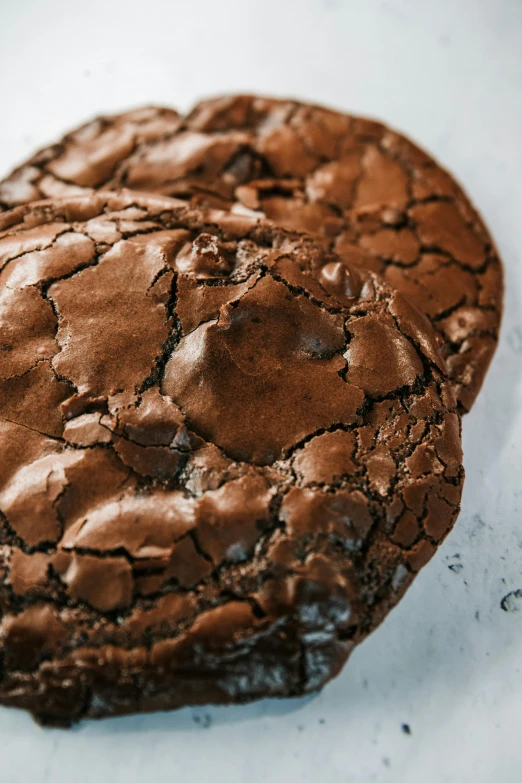 a chocolate cookie with a bite taken out of it, a portrait, unsplash, art nouveau, rocky roads, top and side view, gigantic size, back facing