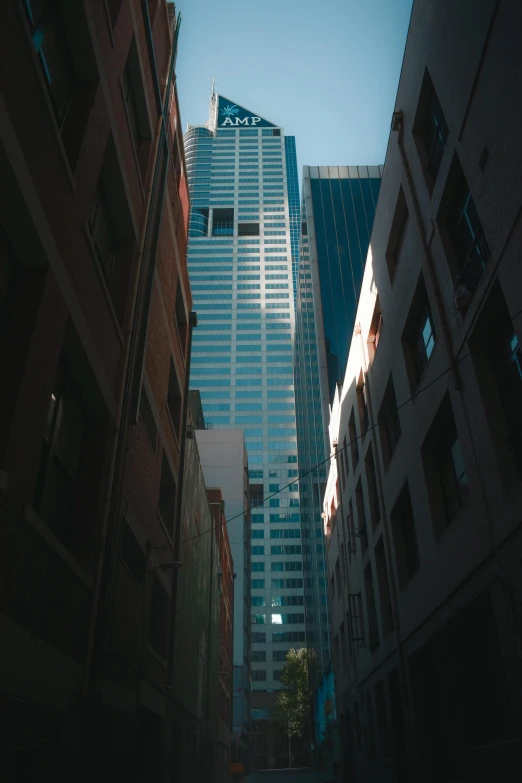 a city street with tall buildings in the background, unsplash contest winner, modernism, alley, low quality photo, buildings made out of glass, high angle vertical