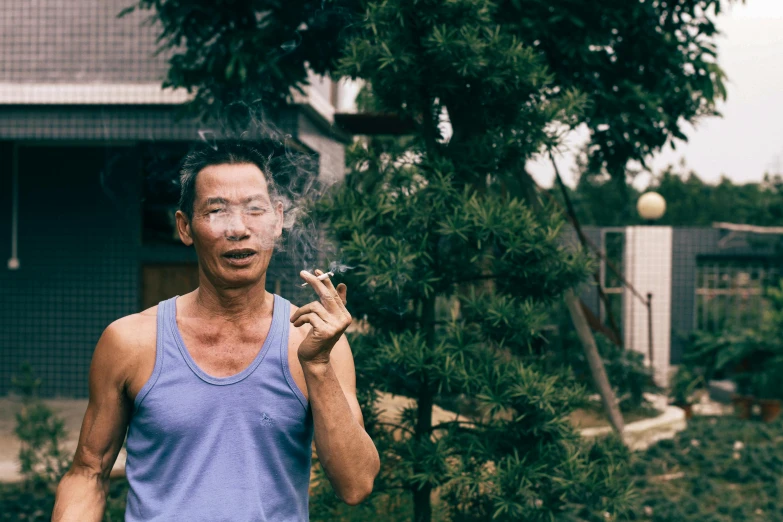 a man smoking a cigarette in front of a house, a portrait, inspired by Zhang Kechun, pexels contest winner, personification of marijuana, zeng fanzhi, slightly muscular, hoang long ly