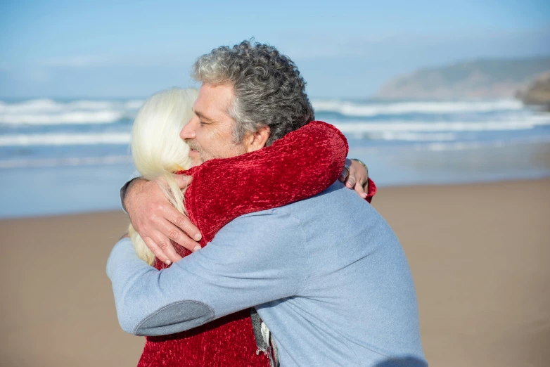 a man and a woman hugging on the beach, bushy white beard, award - winning, 15081959 21121991 01012000 4k, reuniting