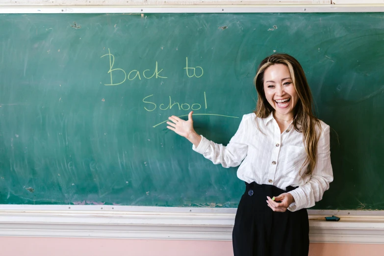 a woman standing in front of a chalk board, trending on unsplash, vancouver school, dilraba dilmurat, back to school comedy, background image