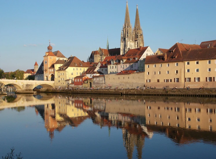 a large body of water with buildings in the background, by Joseph von Führich, pexels contest winner, majestic spires, reflections in copper, beautiful small town, slide show