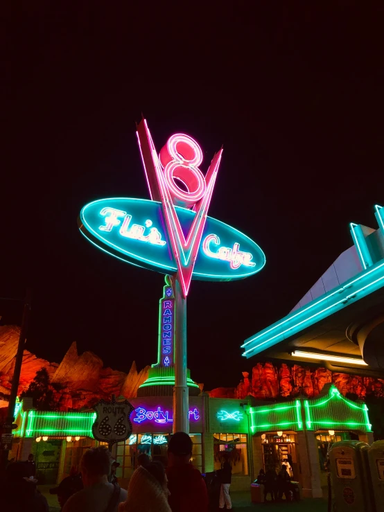 a group of people standing in front of a neon sign, disney 8 k photo, diner caffee, profile image, peaks