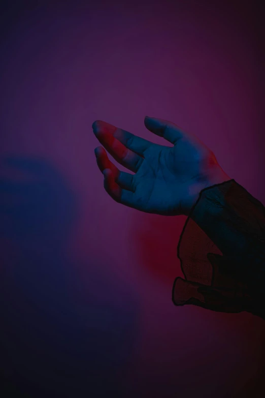 a person's hand reaching for something in the dark, an album cover, inspired by Elsa Bleda, pexels, red blue purple black fade, arms out, asher duran, colored