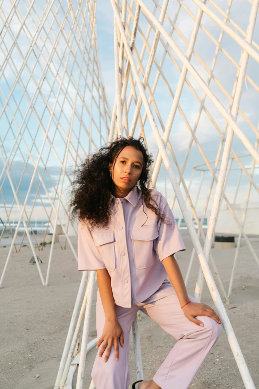 a woman sitting on top of a metal structure, an album cover, trending on pexels, purple overall shorts, wearing a linen shirt, ashteroth, portrait sophie mudd