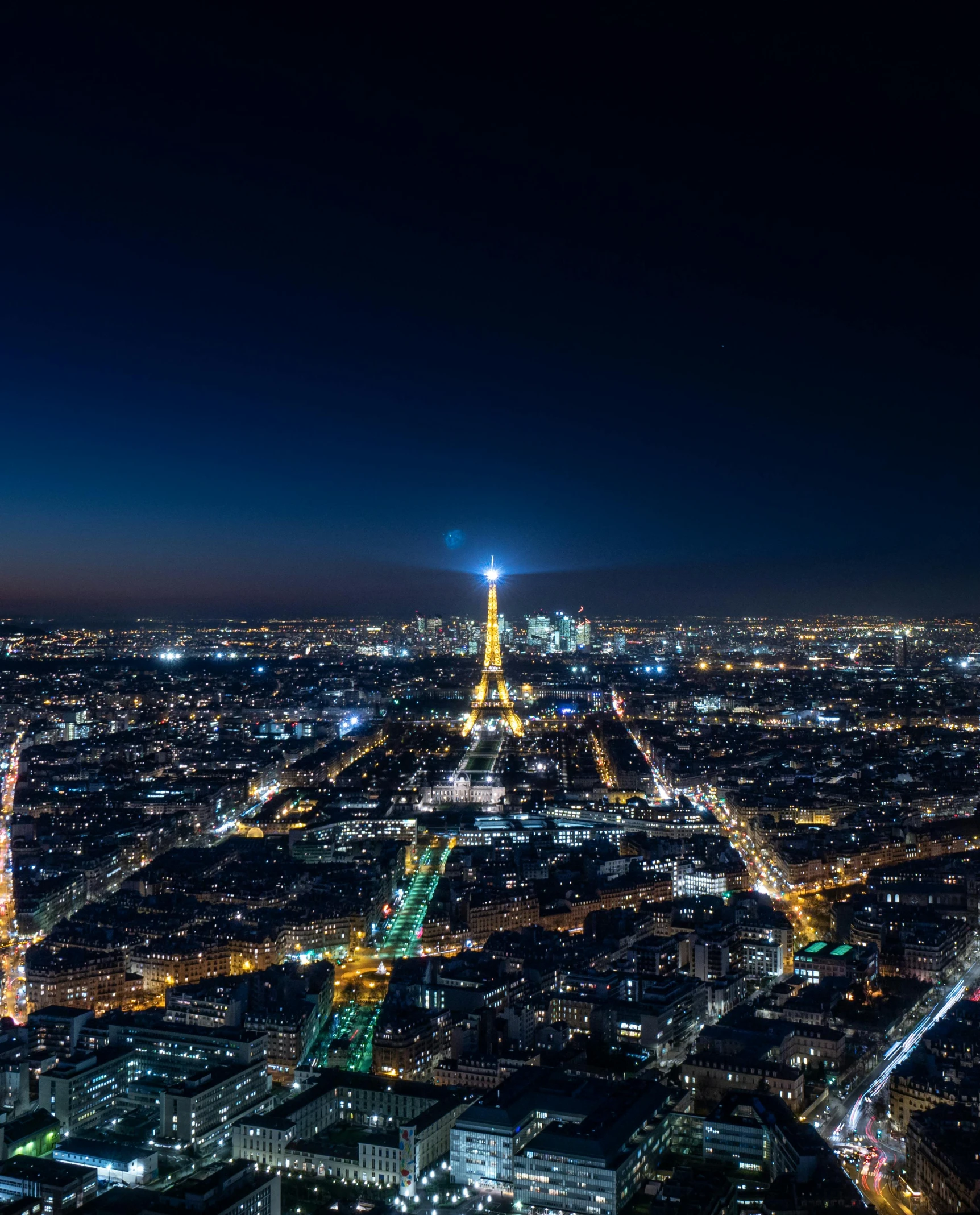 the view of paris at night from the top of the eiffel tower, an album cover, unsplash contest winner, city lights on the horizon, spire, skyline showing, photo from 2022