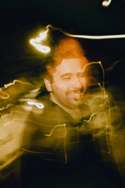 a man that is standing in the dark, an album cover, pexels contest winner, mutahar laughing, yellow lights, grainy quality, reza afshar