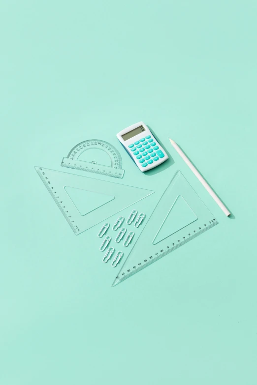 a calculator, ruler, and ruler on a green background, by Julia Pishtar, black and teal paper, high quality product photo, triangles, set against a white background