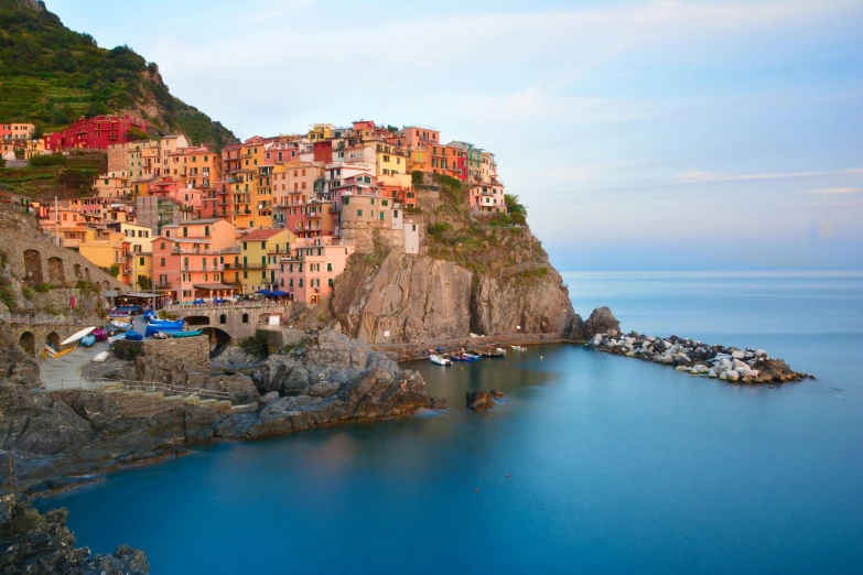 a small town sitting on top of a cliff next to the ocean, by Patrick Pietropoli, pexels contest winner, renaissance, vibrant pastel colors, frank gehry, bulgari, a wooden